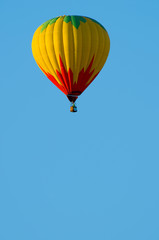 A hoit air balloon in front of a blue sky with copy space