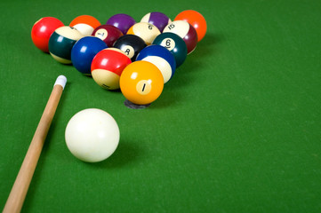 A set of billiards on a green felt table with copy space