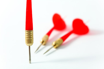three red darts close-up on a white surface