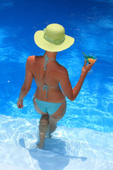 Woman standing  in blue pool