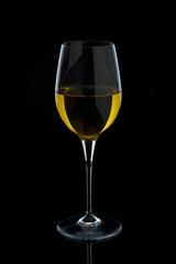 White wine glass over black background