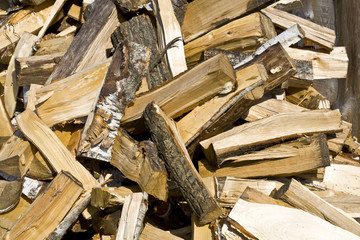 Background formed by a pile of chopped firewood