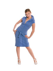 Young woman in blue dress bent playfully with arms on her side.