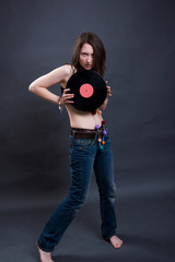 The young woman holds vinyl. Studio shooting