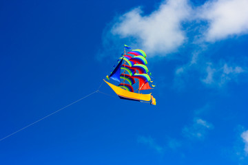 Colorful ship kite in the blue sky.