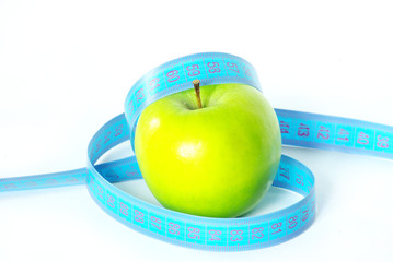 Green apple and measuring tape