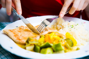 Tasty beefsteak closeup. Young woman eating beefsteak.