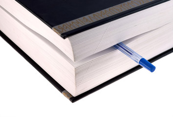 Book with pen on white