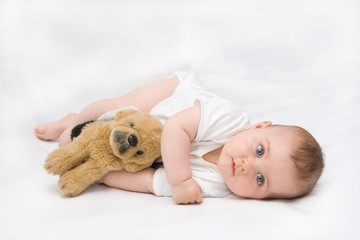 little, cute baby boy lying on white background