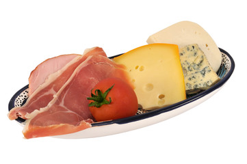Ham, cheese and tomato in a oval dish isolated on white.