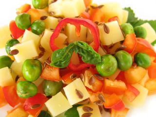 Salad with cheese, flax seeds, paprikas, greenpeas and basil