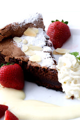 chocolate cake with a strawberry on white plate