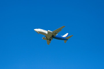 Fototapeta na wymiar The passenger plane on a background of the dark blue sky
