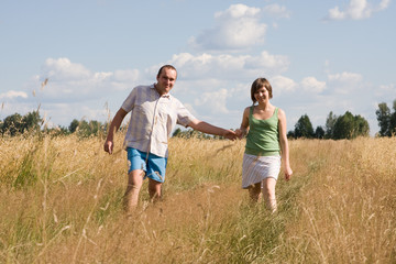 happy couple walking together on a sunny day