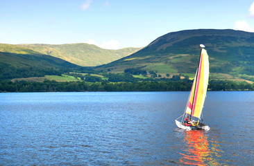 Fototapeta premium sailboat on a Scottish lake, beautiful hills in background