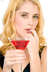 A pretty young woman holding a cocktail