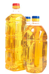 Three bottles filled with sunflower oil. Two high and one low.