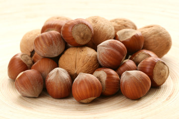 close-ups of hazelnuts and walnuts on wooden table
