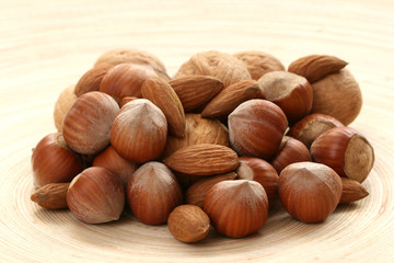 close-ups of hazelnuts and walnuts on wooden table