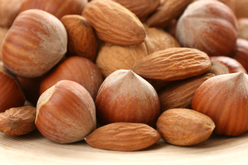 close-ups of hazelnuts and walnuts on wooden table