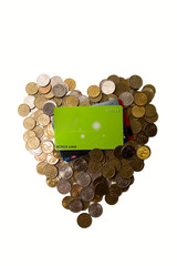 Coins as heart and cards on white background