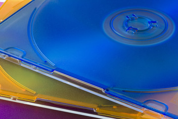 three CD or DVD optical disks in colorful jewel cases