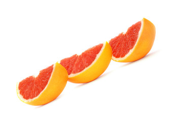 Sliced grapefruits against white background