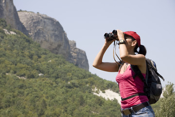 woman with the binoculars in the mountains