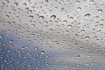 Background: rain drops on a polyethylene awning