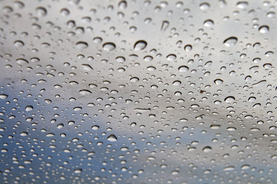 Background: rain drops on a polyethylene awning