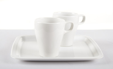 White cups on white plate