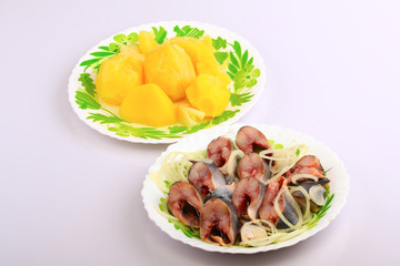 Boiled potato and herring with an onions in oil