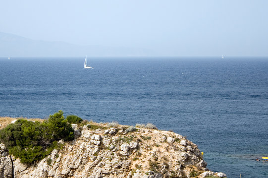 View over Sea and Rock and three sailboats