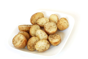 Roasted potatoes with herbs on a white plate