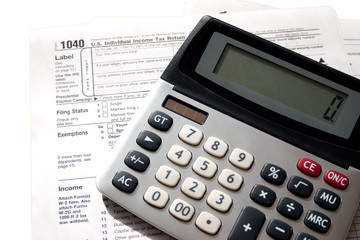 tax papers with a calculator on top