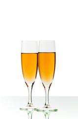 Two wine glasses on the reflective background