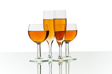 Four wine glasses on the reflective background
