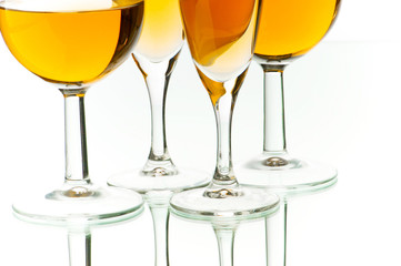 Four wine glasses on the reflective background