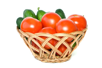 Basket with tomatoes and cucumbers isolated on the white