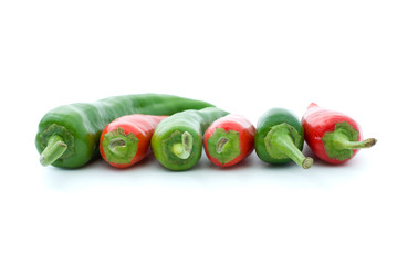 Some red and green hot peppers isolated on the white - side view