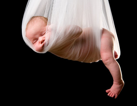 Stork Baby Package. 14 days old newborn carried in white cloth
