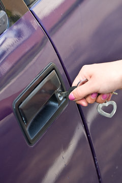 hands and car keys woman heart on key chain