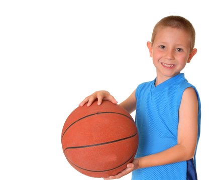 Young Boy Playing With A Basketball Isolated On White