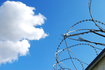 Barbed wire in front of sky