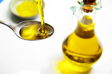 olive oil being poured into a spoon