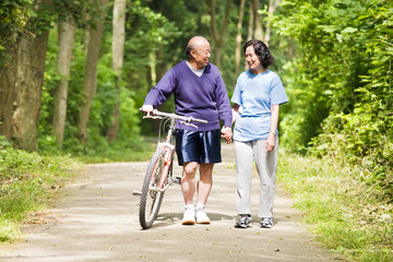 A couple senior asian talking and exercising at a park