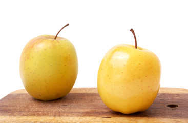 Two apples on a board.