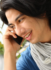 Man smiling and talking on the phone