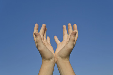 Two Human hands on a clear sky