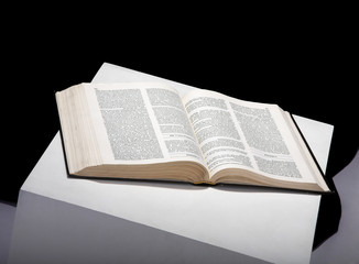 The open book on a black background